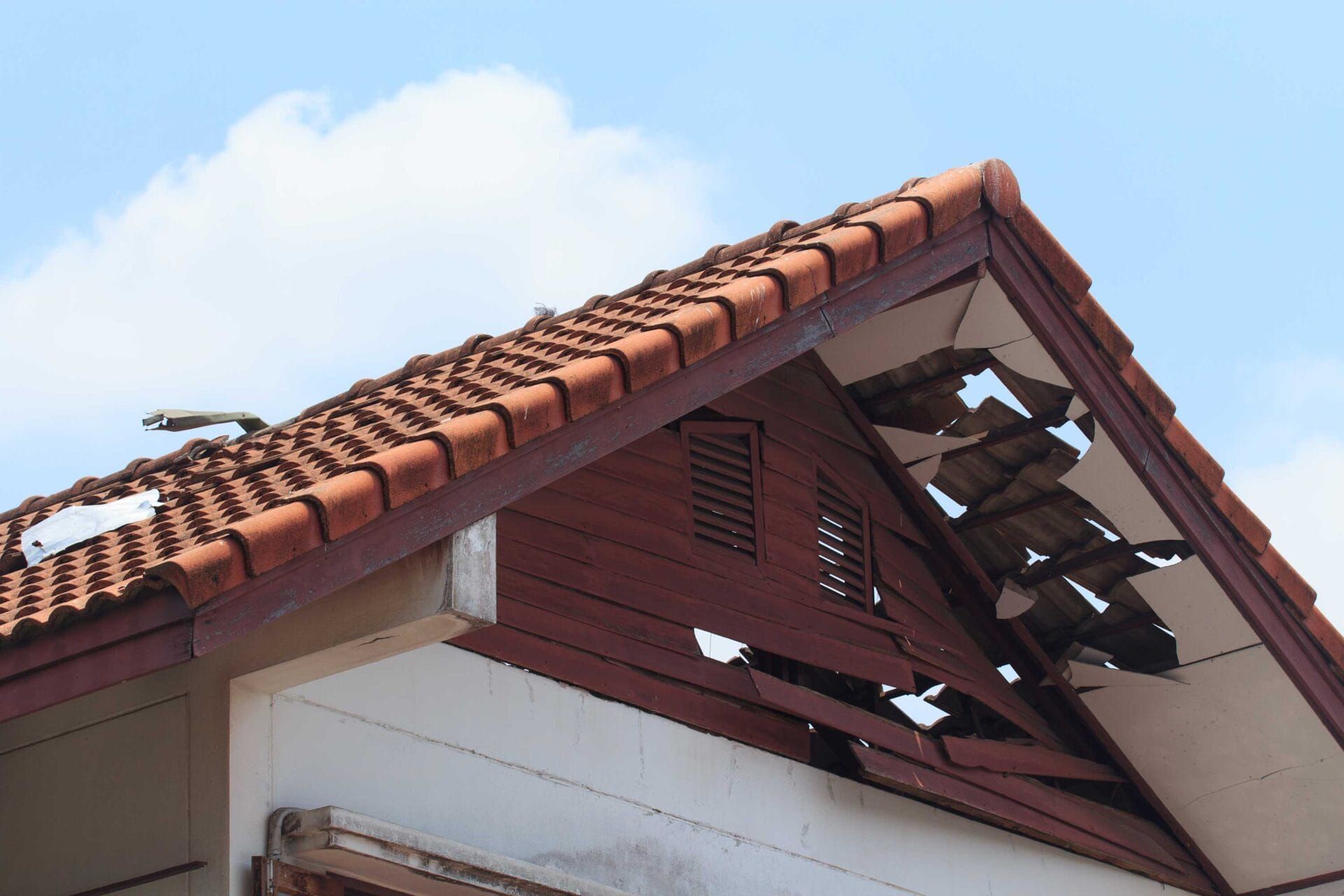 The roof of a house has been damaged by a storm.