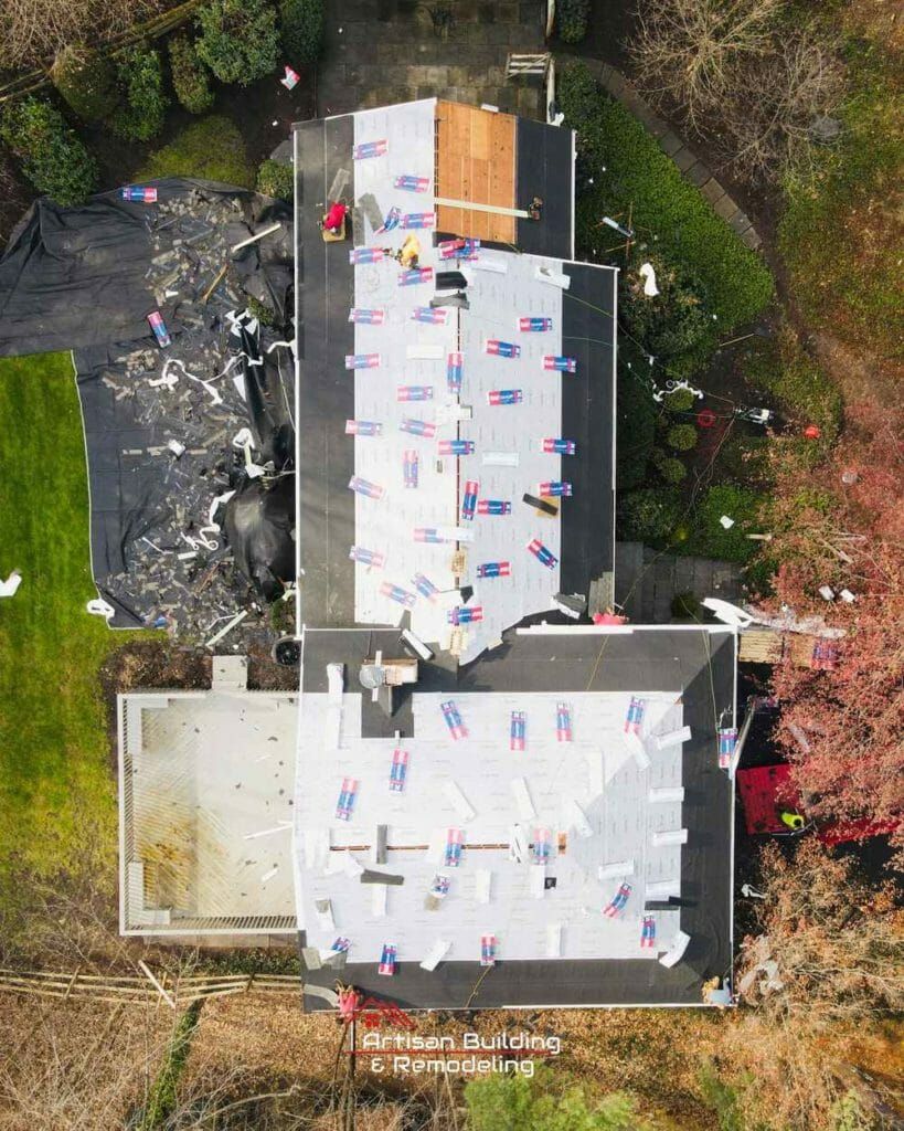 An aerial view of a house with a roof being installed.