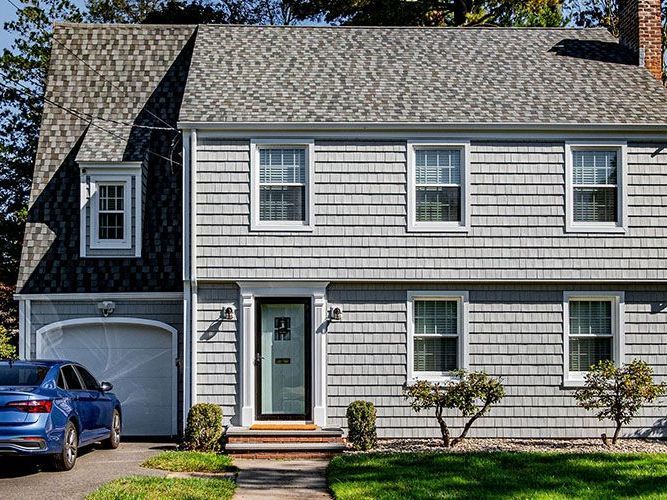 A man is standing on a ladder in a building under construction.