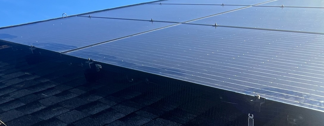 A close up of a roof with a blue sky in the background.