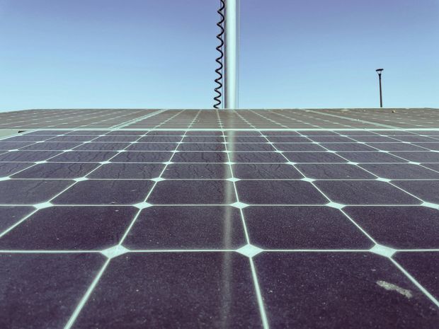 A row of solar panels against a blue sky