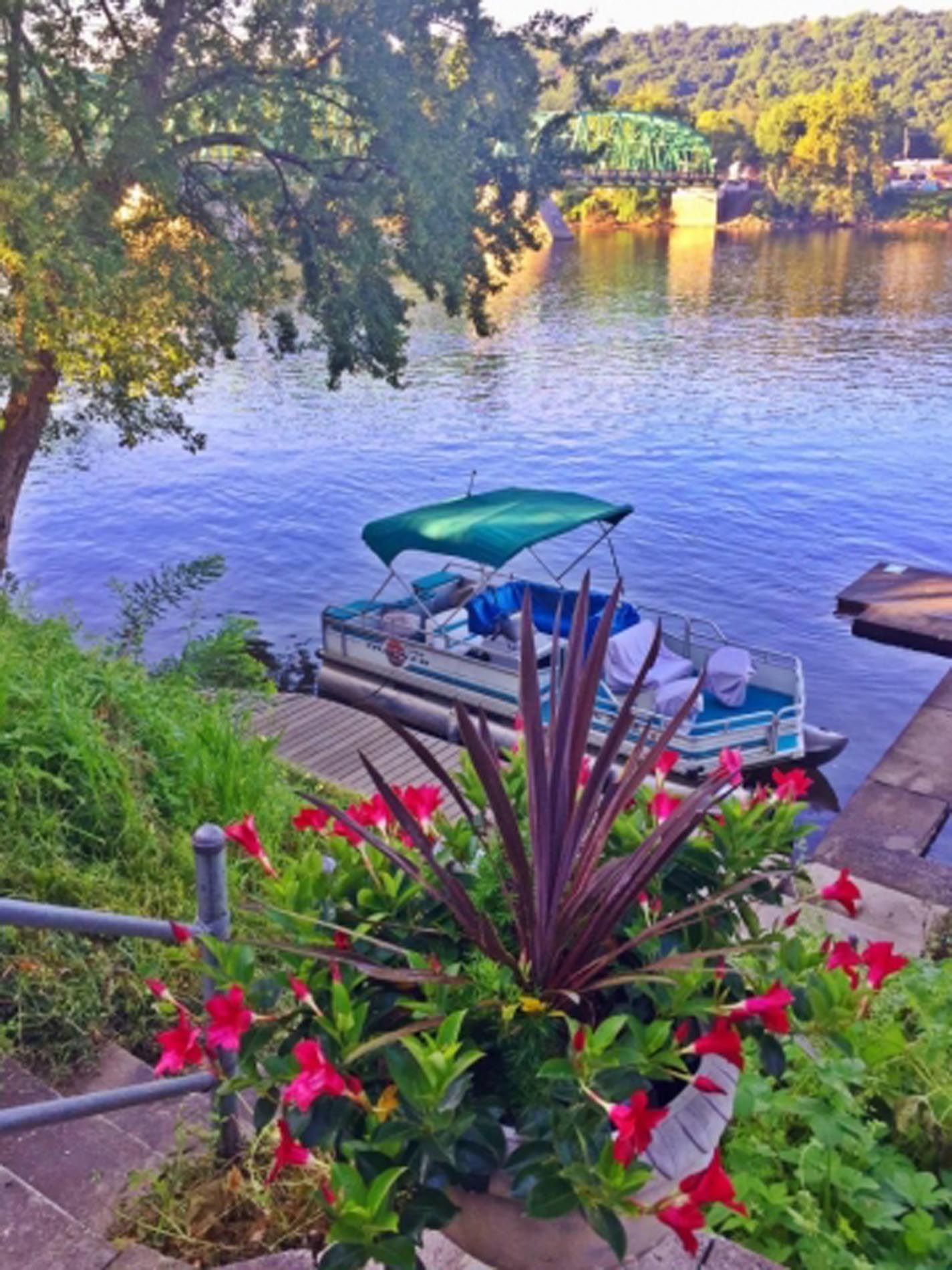 A boat is docked on the shore of a lake