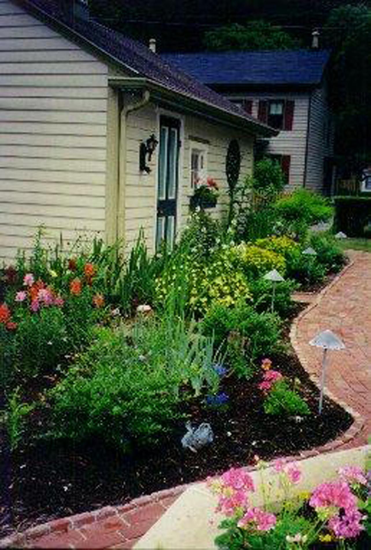 A house with a lot of flowers in front of it