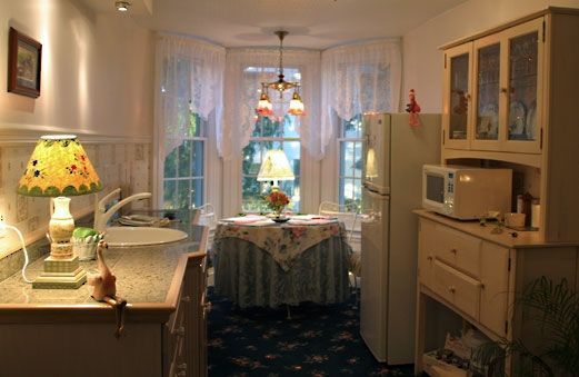 A kitchen with a table and a lamp in it