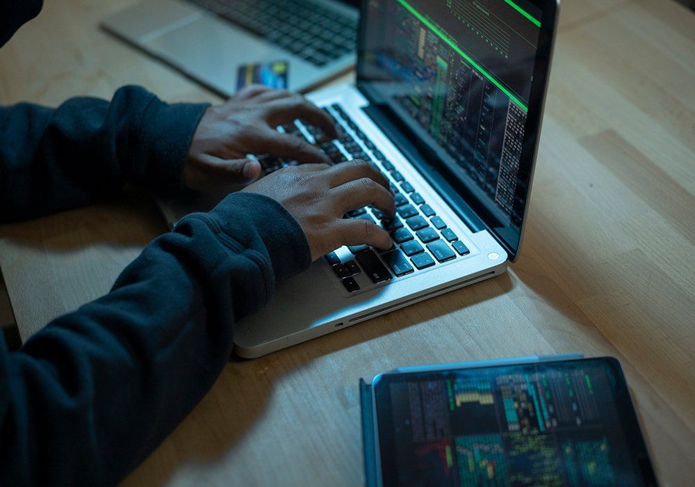 Closeup of Hands Typing on Laptop — Berwyn, PA — AAP Security and Telecom, LLC