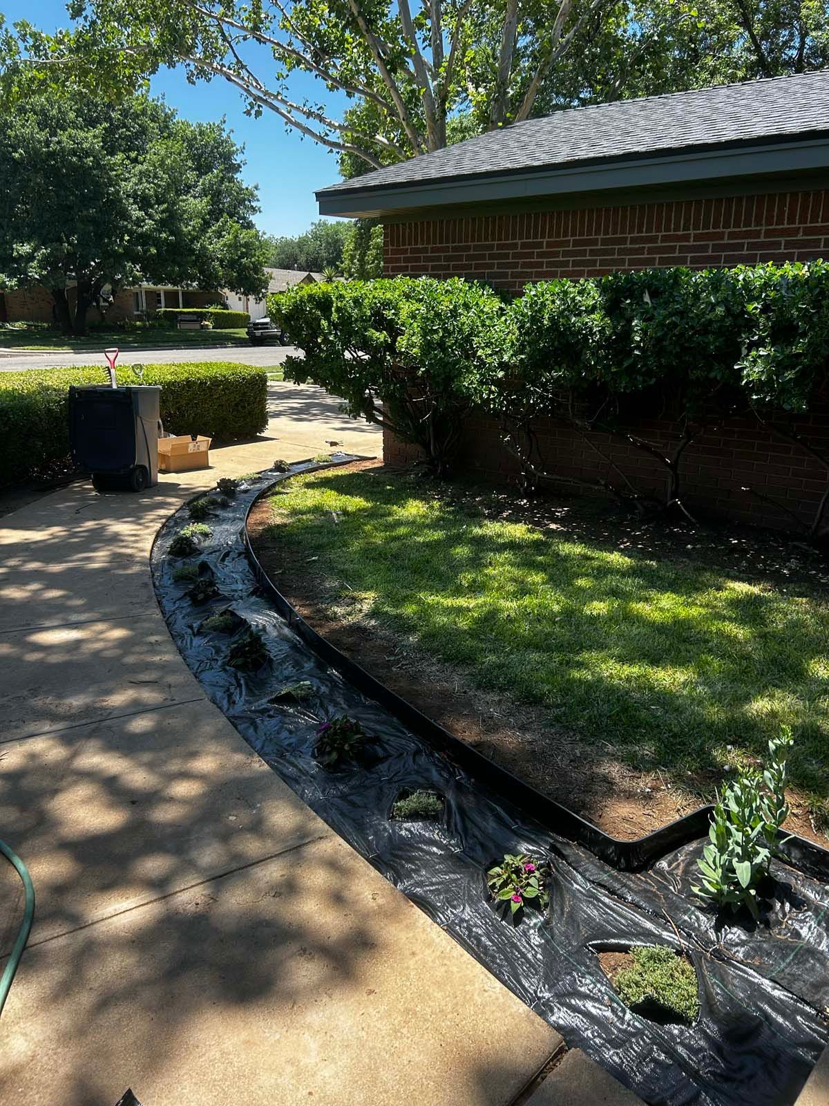 A brick house with a lush green lawn in front of it.