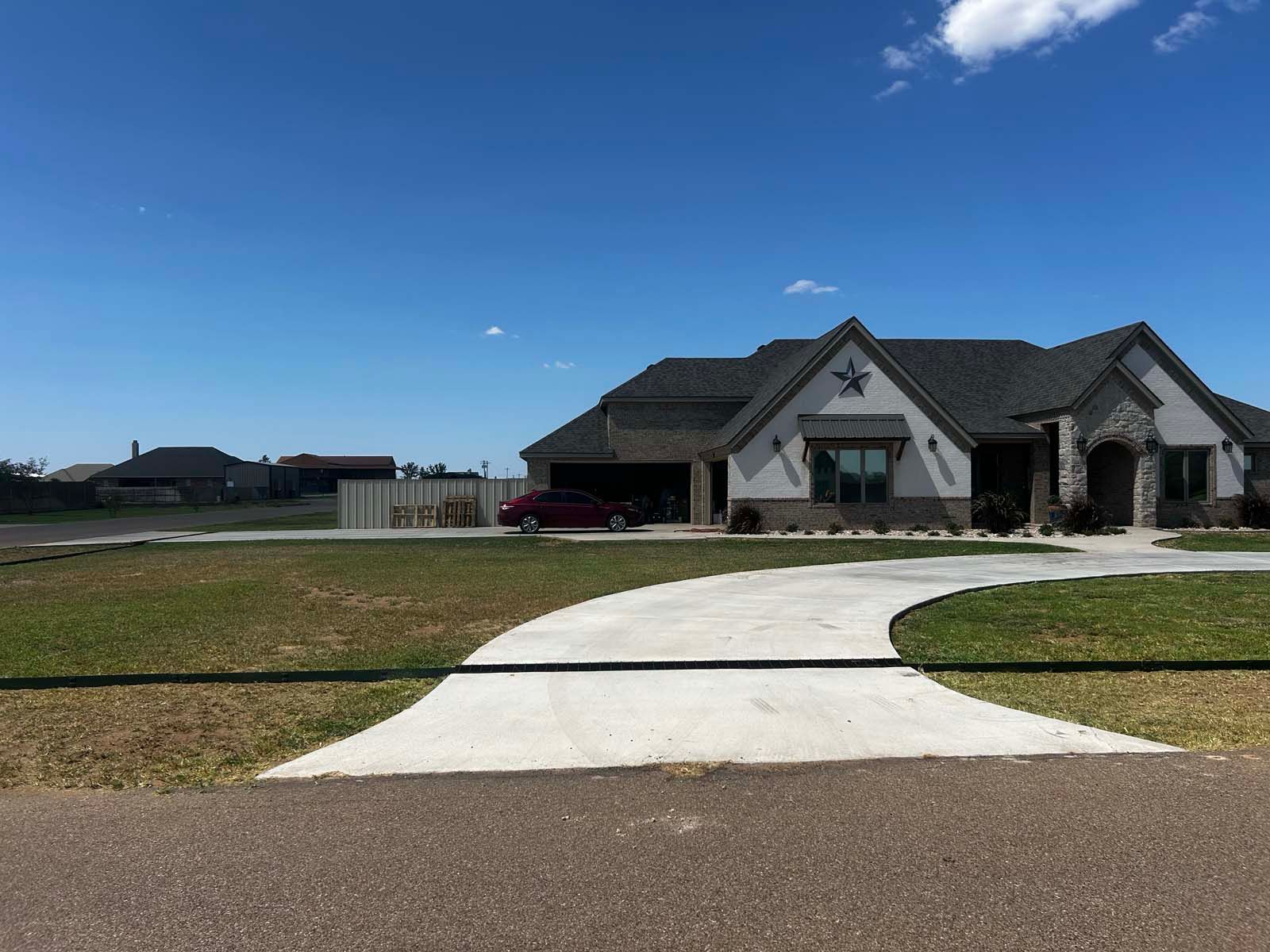 A large house with a red car parked in front of it