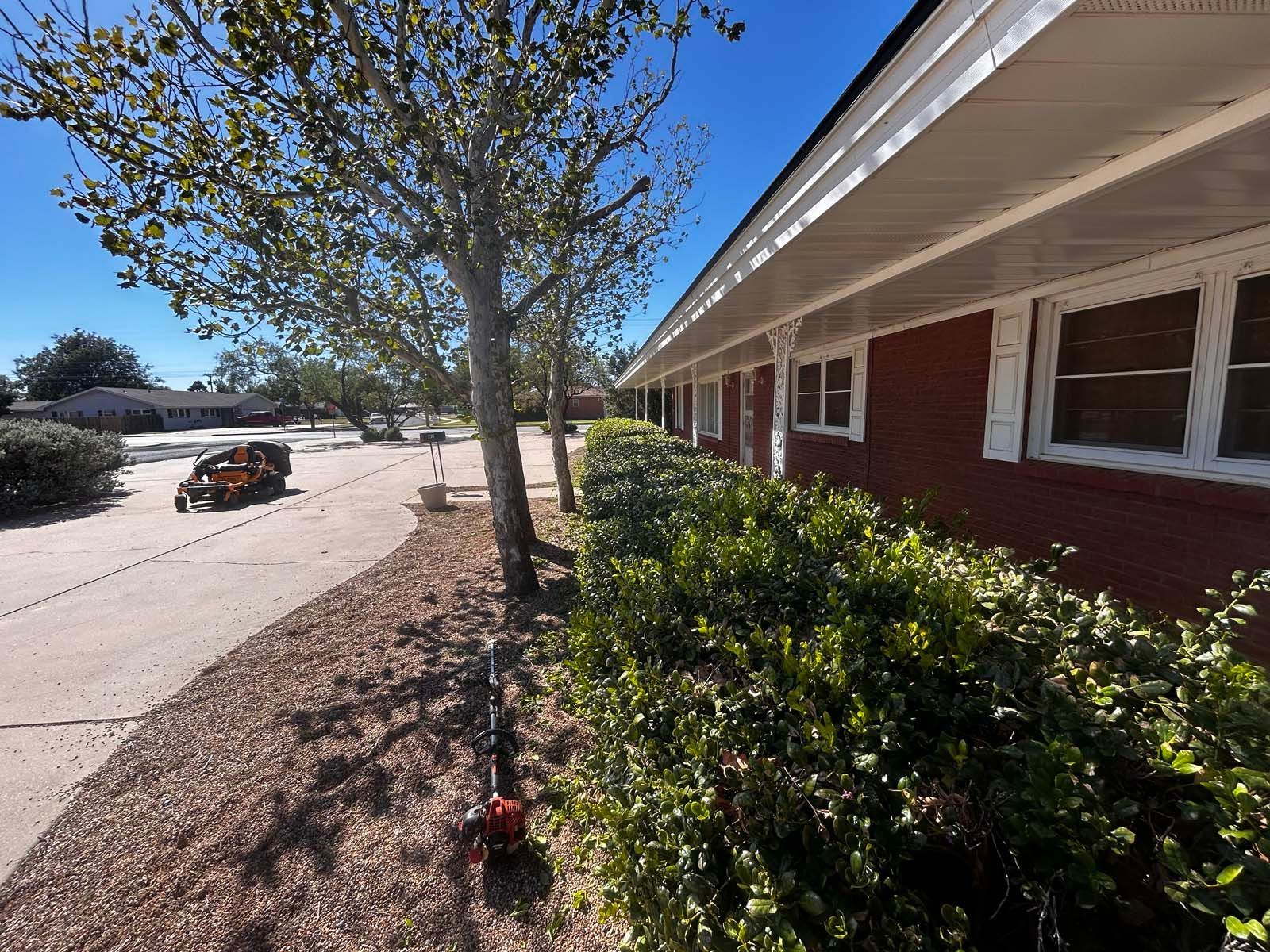 A red brick house with a white roof and white trim