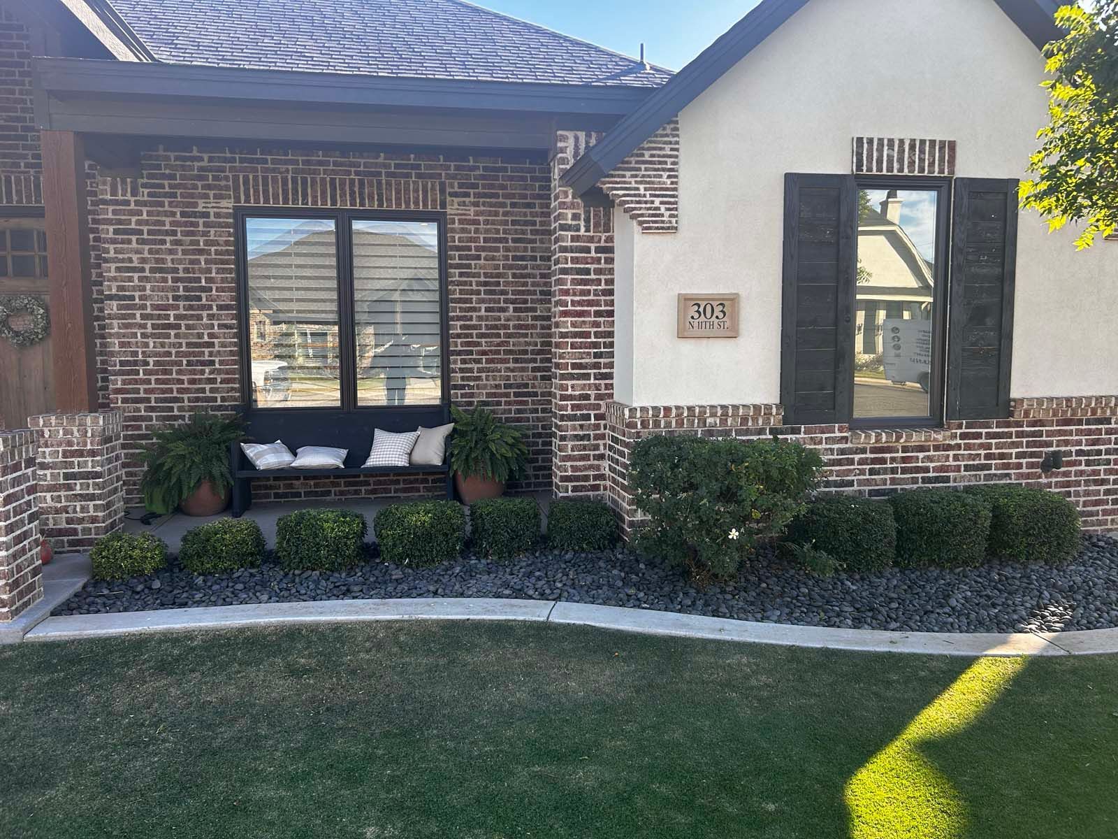 A brick house with a bench in front of it