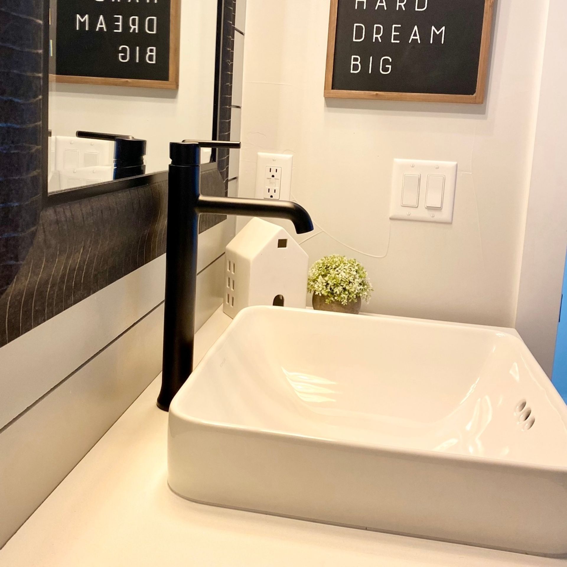 E.Squared Custom Plumbing Heating and Air - Black faucet above a white rectangular sink on a countertop;