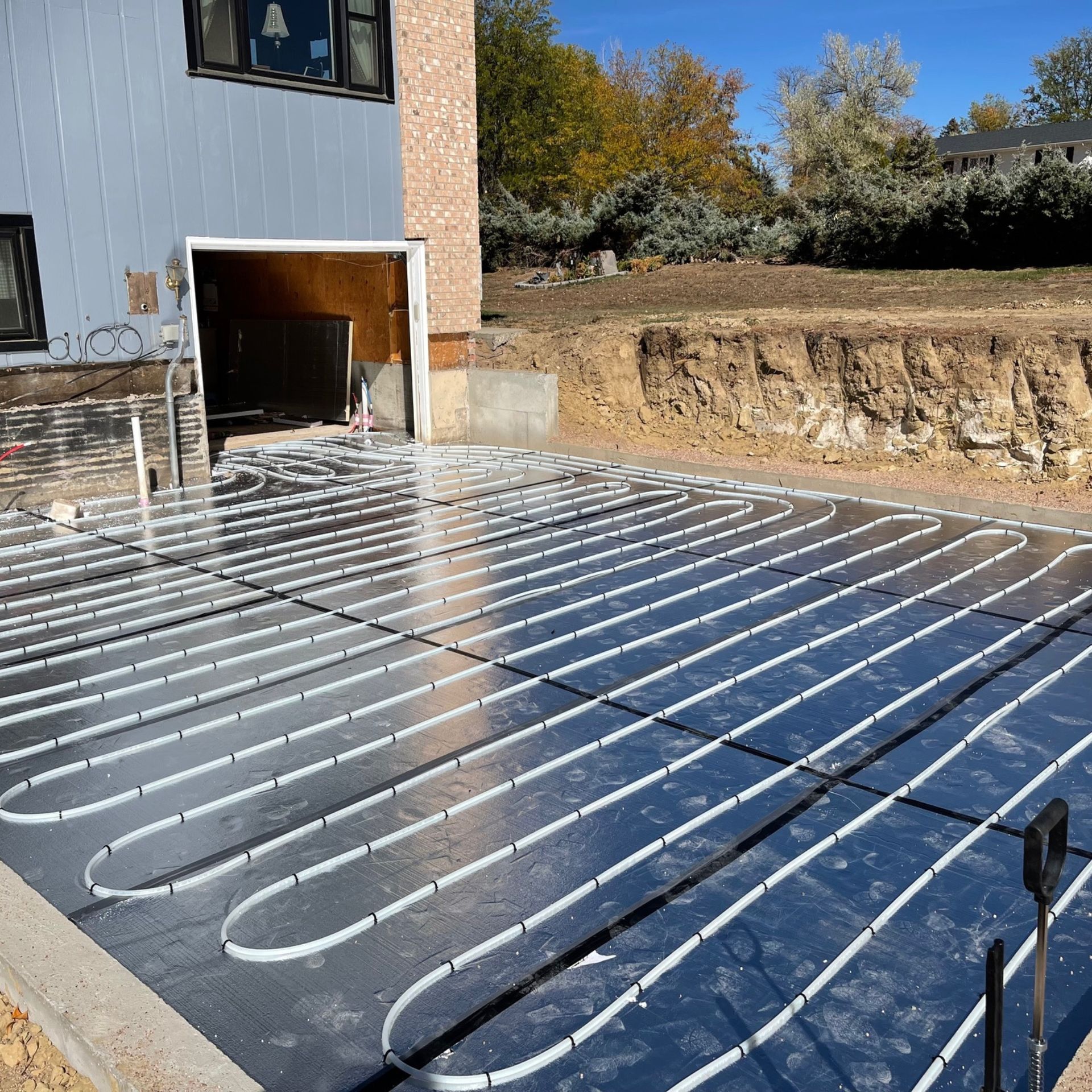 E.Squared Custom Plumbing Heating and Air - Pipes for radiant floor heating on a black surface. 