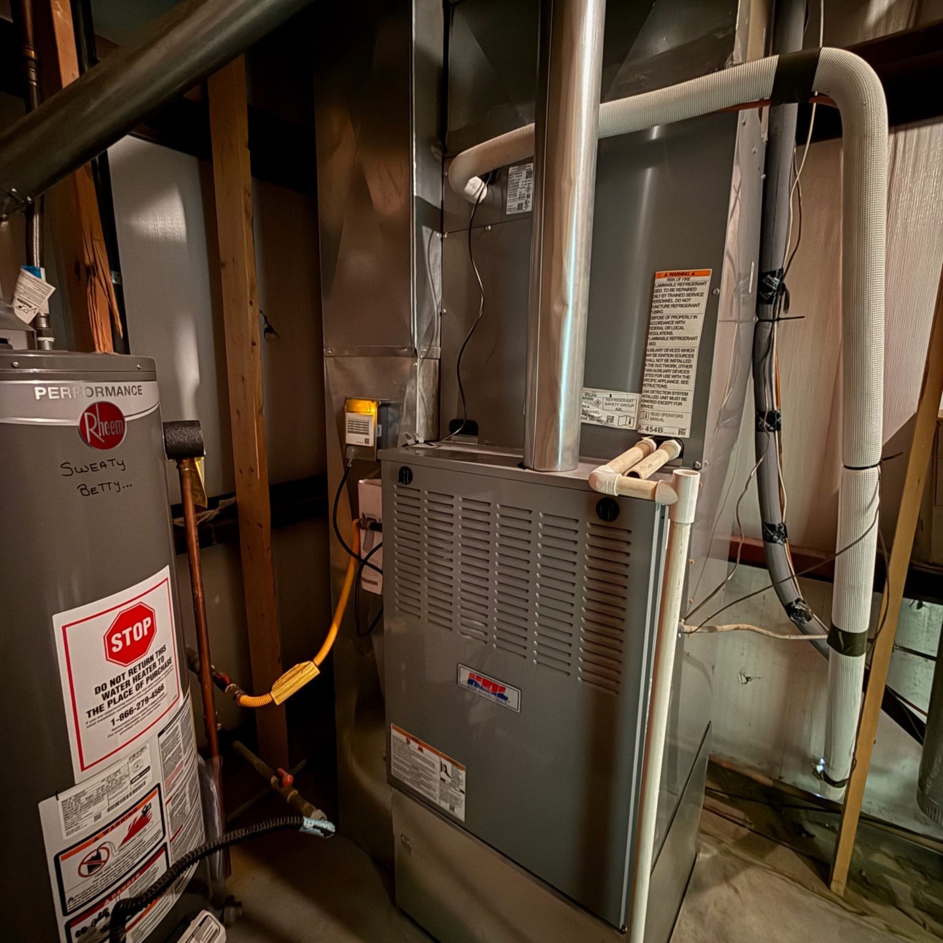 E.Squared Custom Plumbing Heating and Air - A furnace and water heater in a basement.