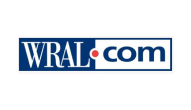 the logo for wral.com is blue and white on a white background .
