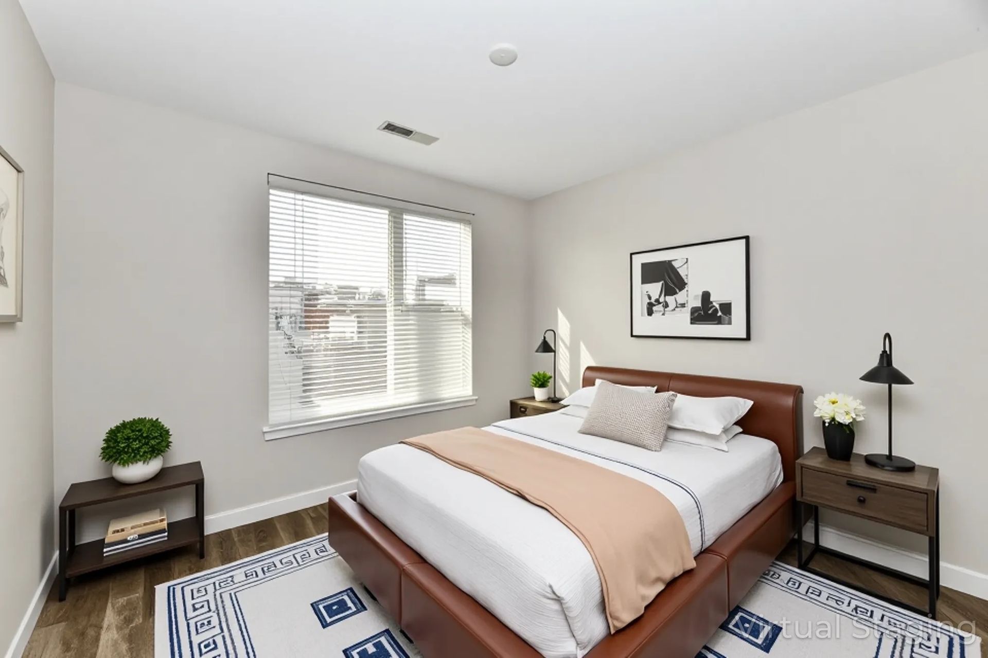 An empty living room with hardwood floors and a ceiling fan.