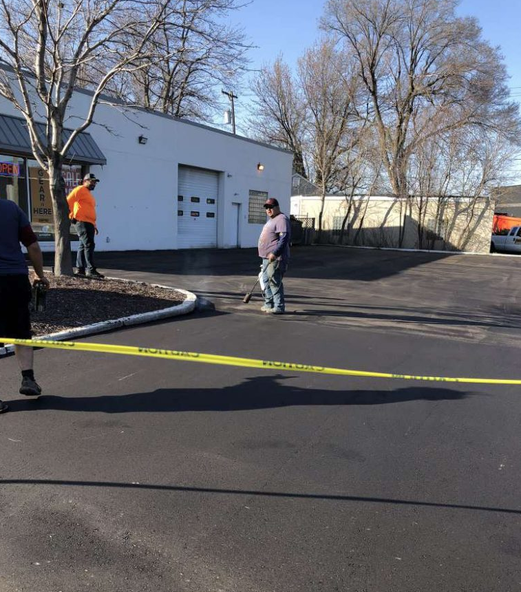 A man walking down a street with a yellow tape that says caution