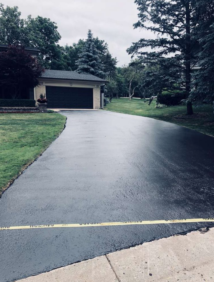 A driveway leading to a house with a garage