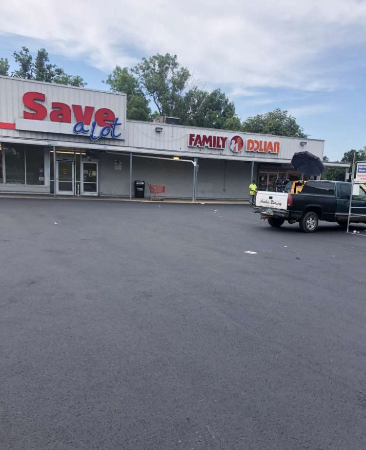 A truck is parked in front of a store called save a lot