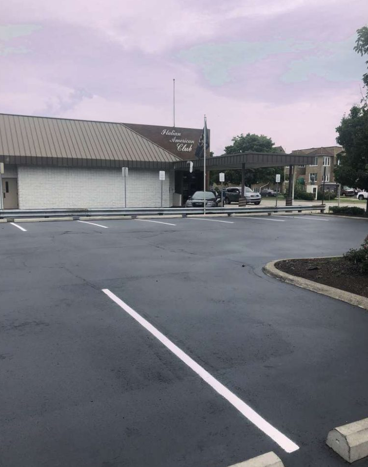 A parking lot with a building in the background