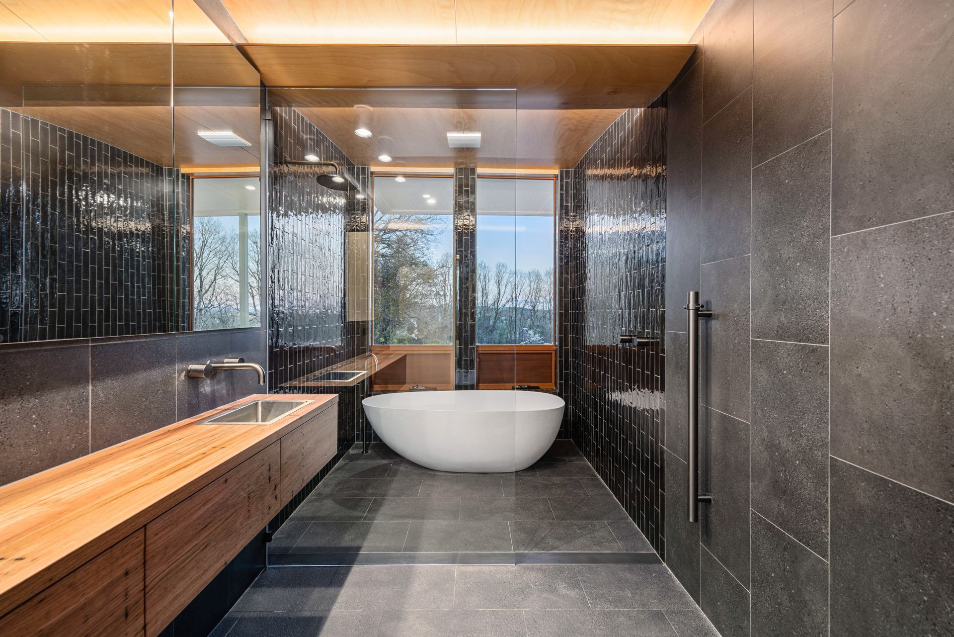 Modern Bathroom With Dark Grey Tile, Wooden Vanity — Croker Plumbing and Gas in Goulburn, NSW