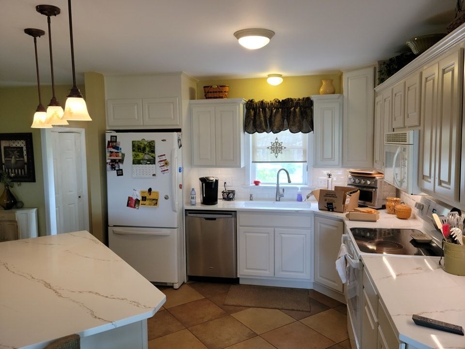 A kitchen with white cabinets and stainless steel appliances in Manheim, PA