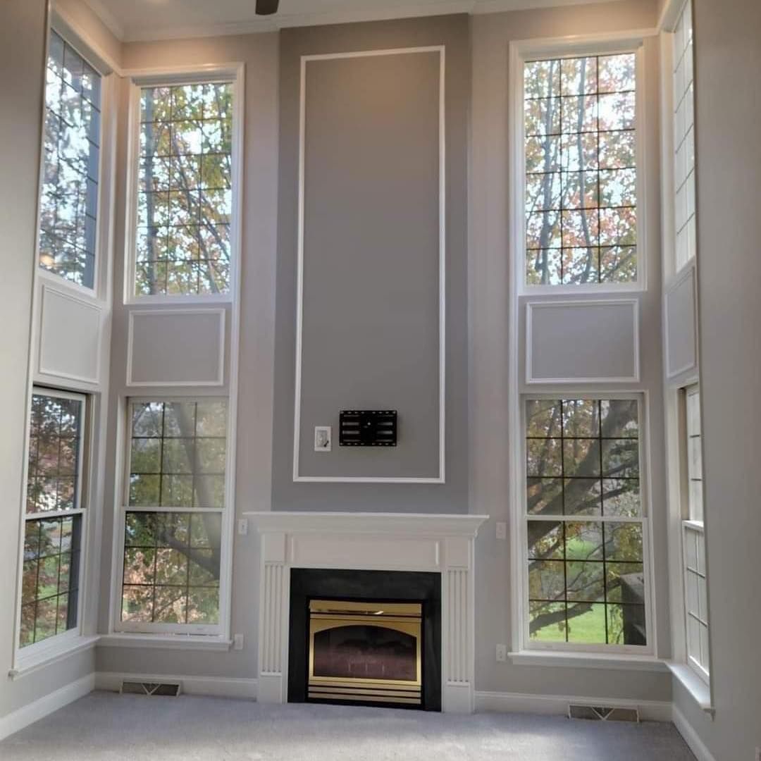 A living room with a fireplace and lots of windows in Bowmansville, PA