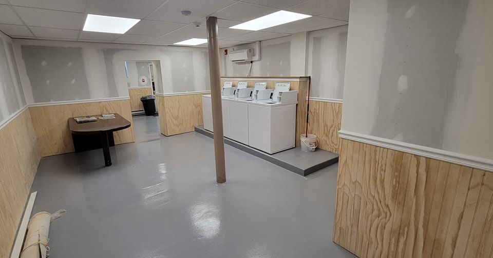 A room with a row of washers and dryers in New Holland, PA