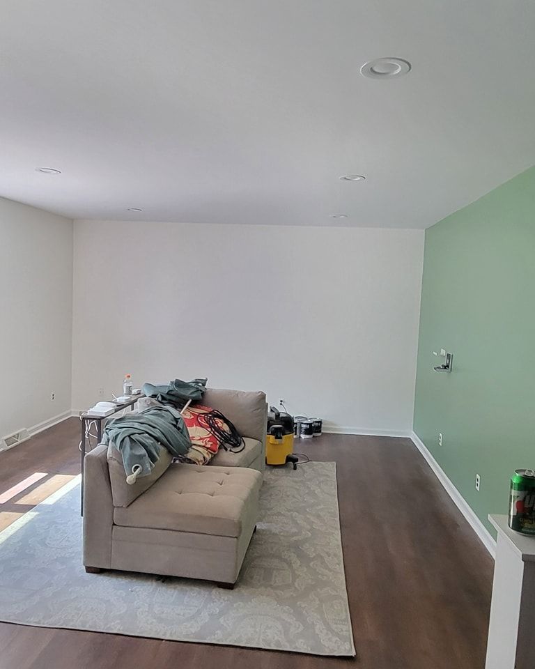 A living room with a couch , rug , and white walls in New Holland, PA