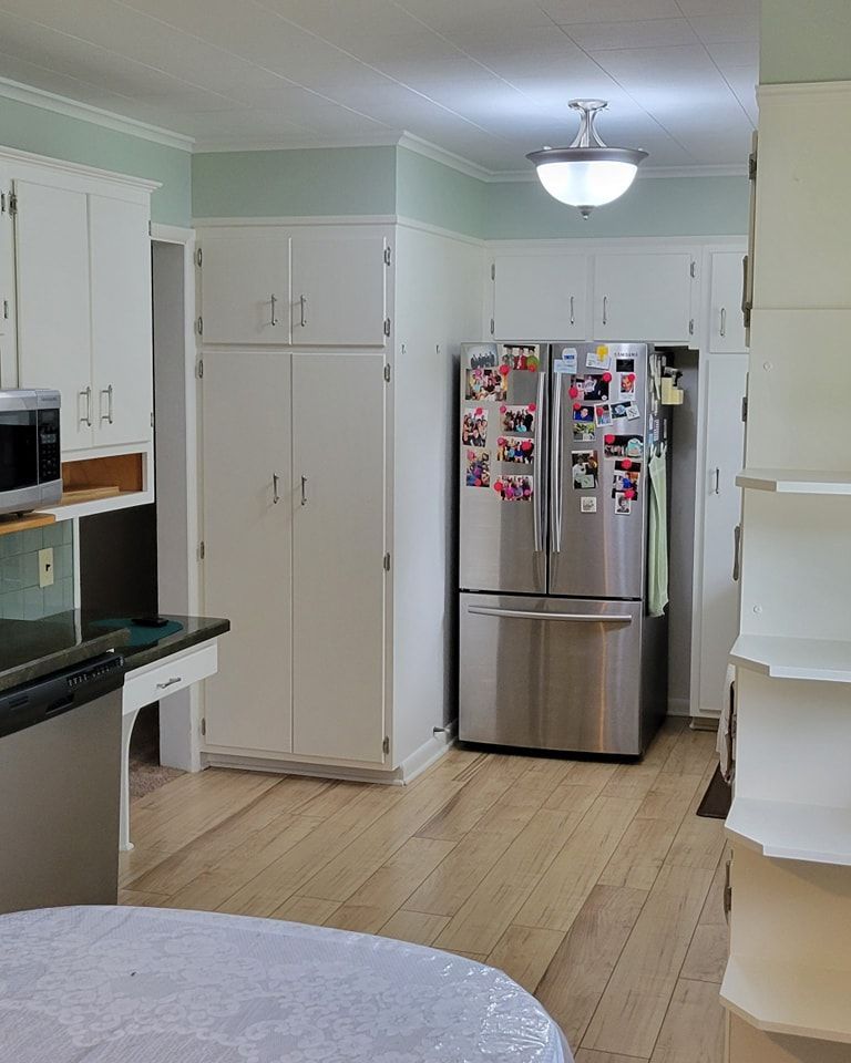 A kitchen with a stainless steel refrigerator with stickers  in Manheim, PA