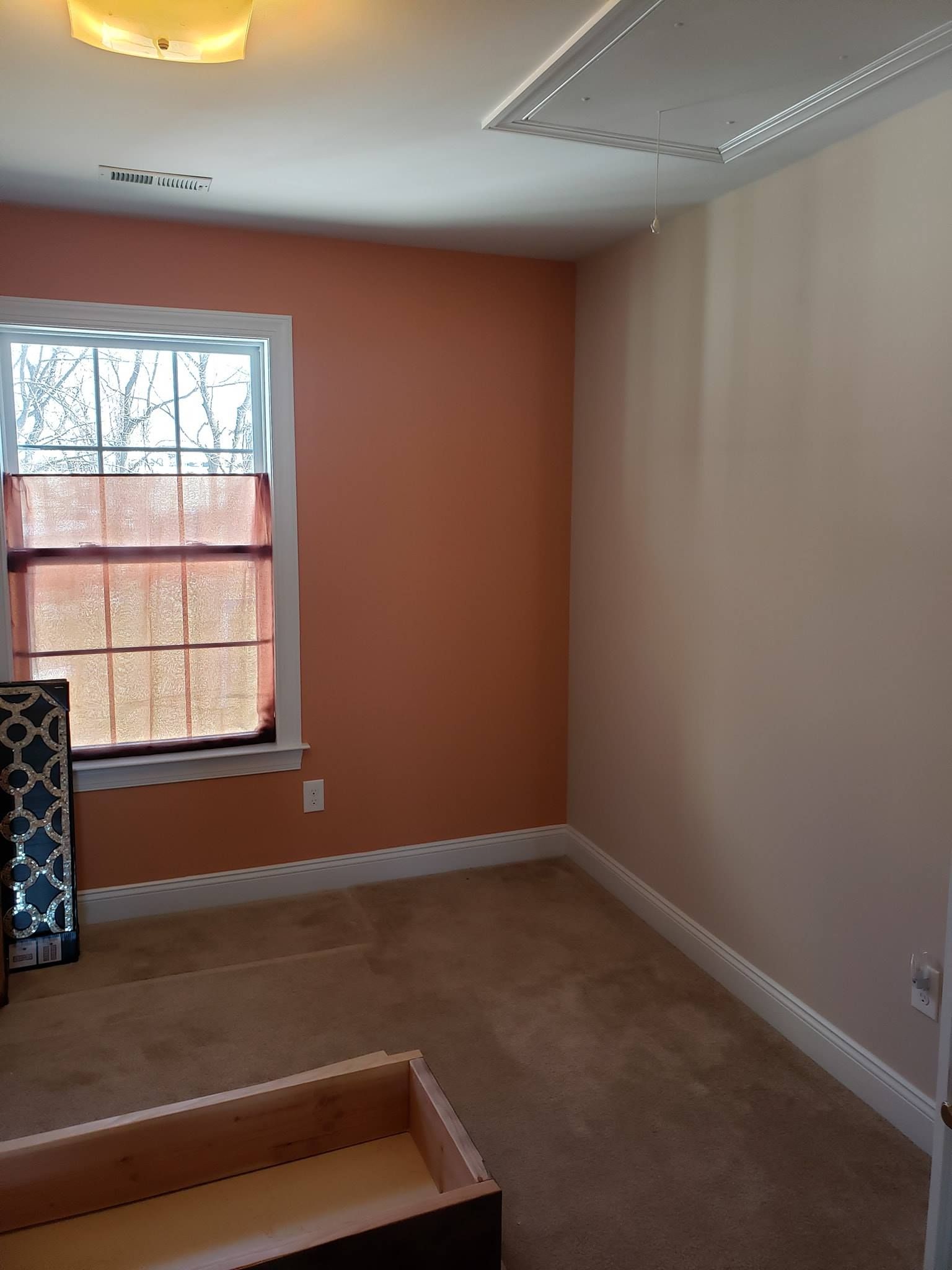 An empty room with pink walls and a window in interior painting Morgantown, PA