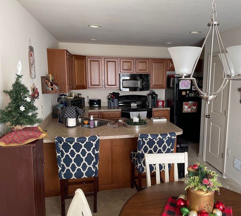 a kitchen with a table and chairs and a christmas tree