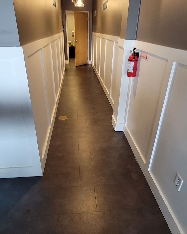 A bathroom with a toilet , sink and mirror.