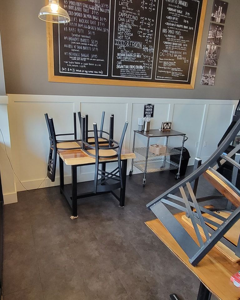 A restaurant with tables and chairs stacked on top of each other