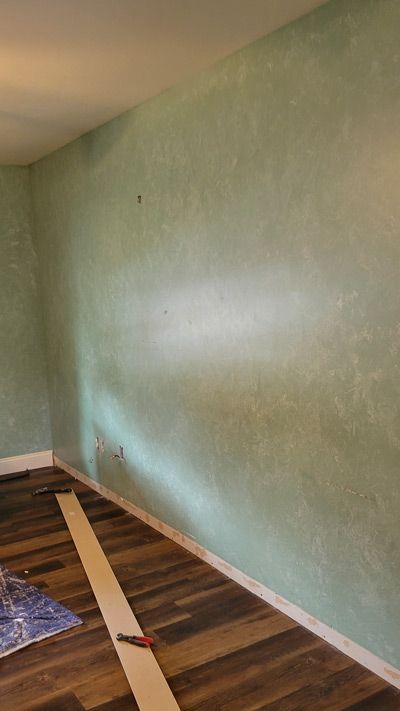 A hallway with a staircase in the background