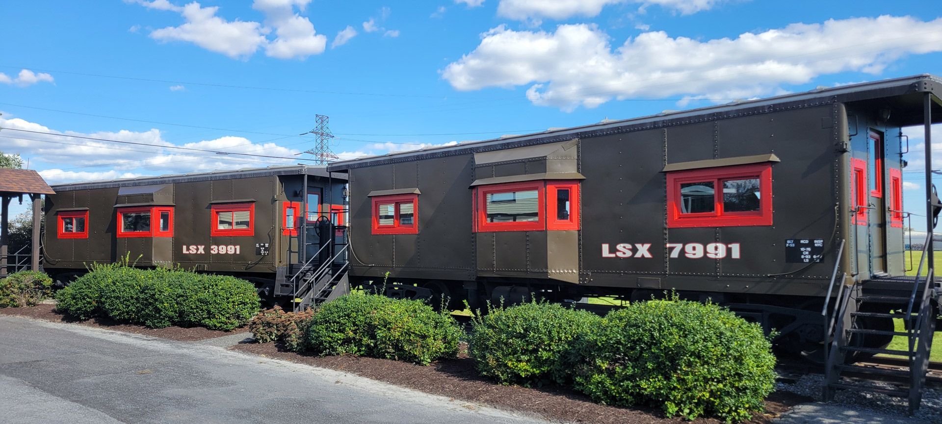 A train car is parked on the side of the road.