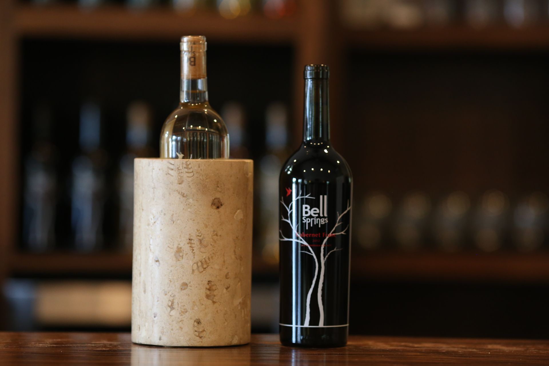 A bottle of bell wine sits next to a bottle of wine at Bell Springs