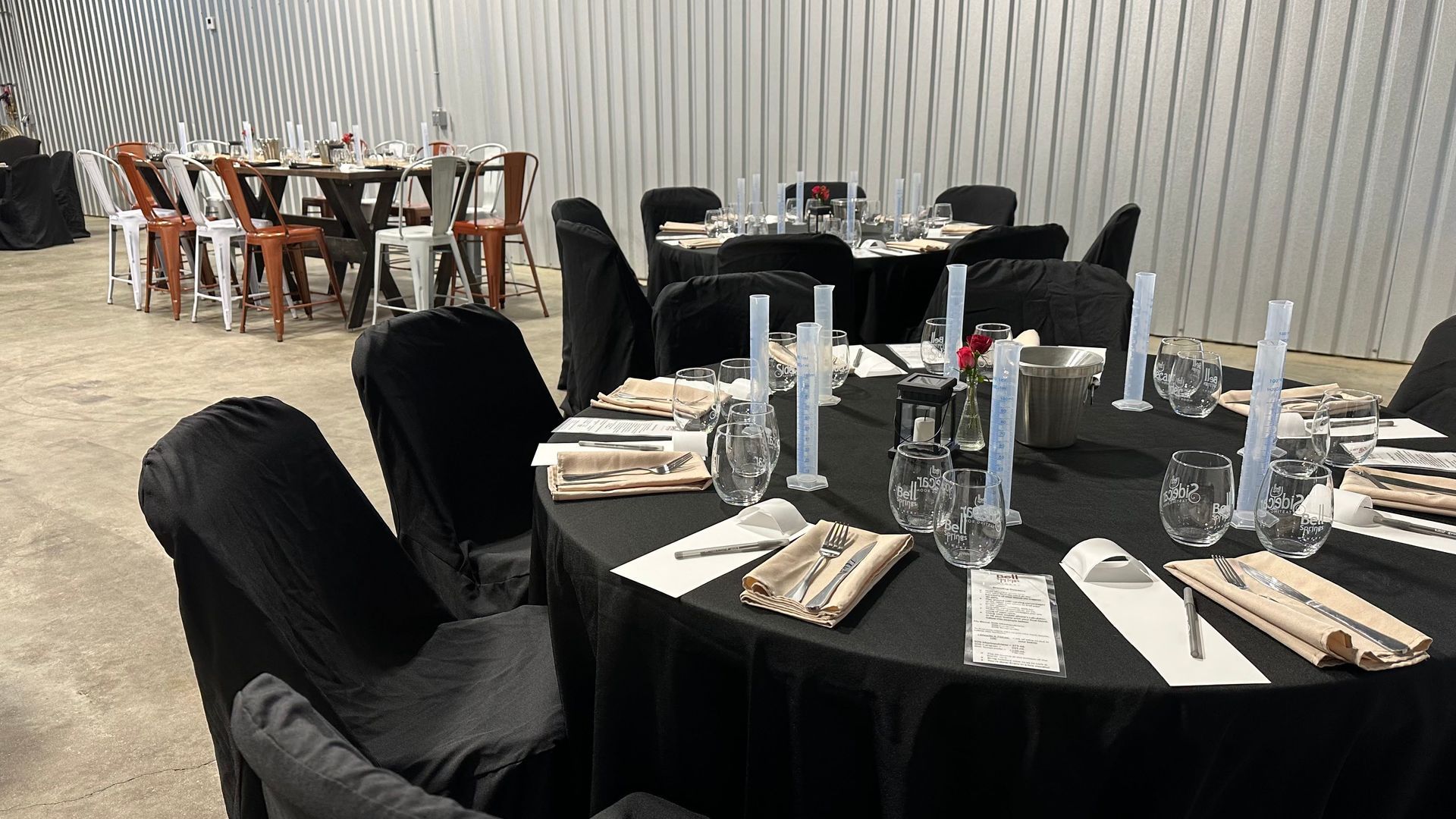 A room with tables and chairs set up for a party.