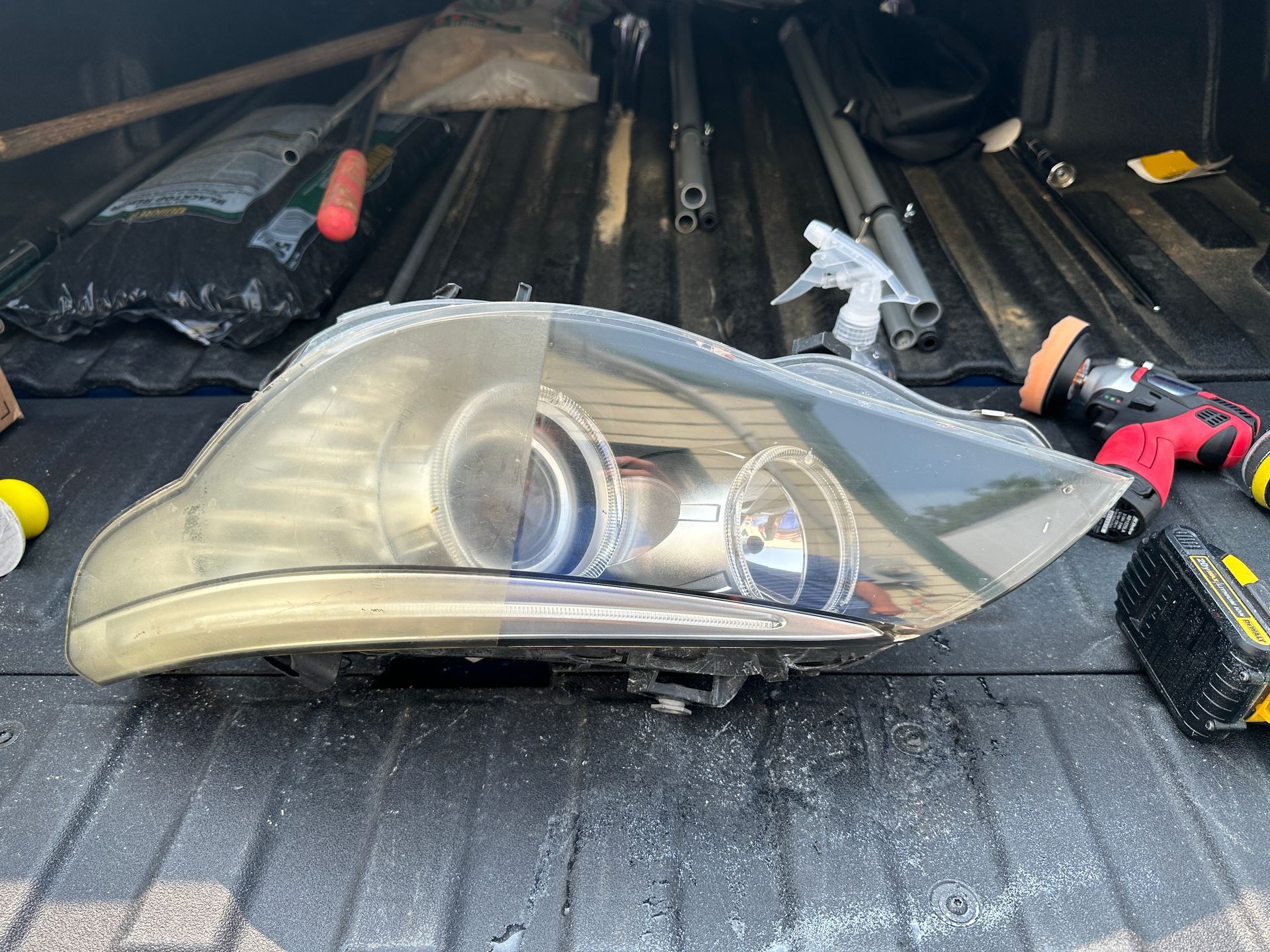 a car headlight is sitting in the back of a truck .