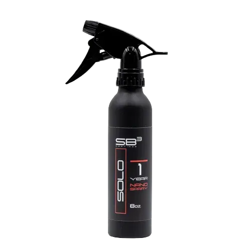 a black spray bottle with a black sprayer on a white background .