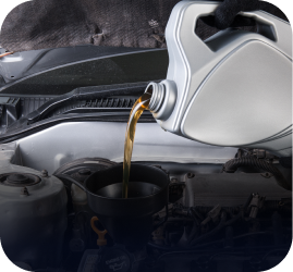 A gloved hand pours golden engine oil from a plastic jug into a car engine using a black funnel | Ames Automotive STC