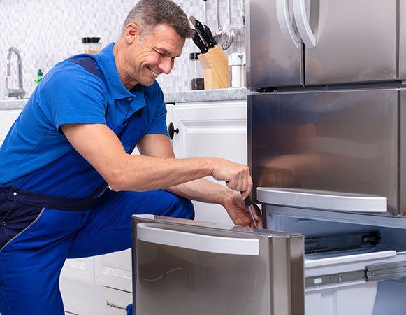 Man Repairing Refrigerator — Wichita, KS — Appliance Doctor