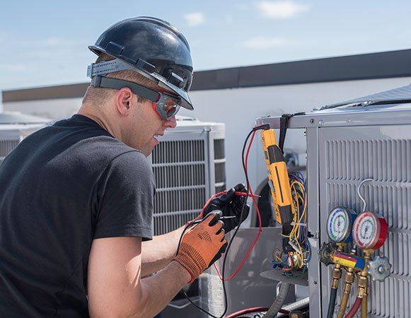 Man Repairing Air Conditioner — Wichita, KS — Appliance Doctor