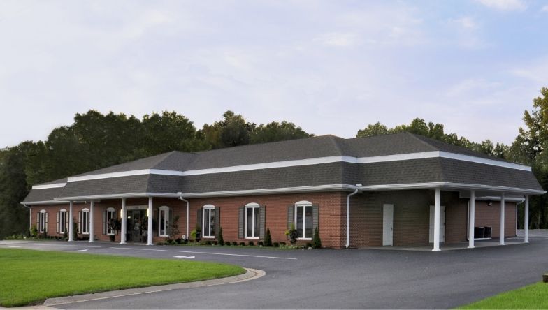 A large brick building with a black roof