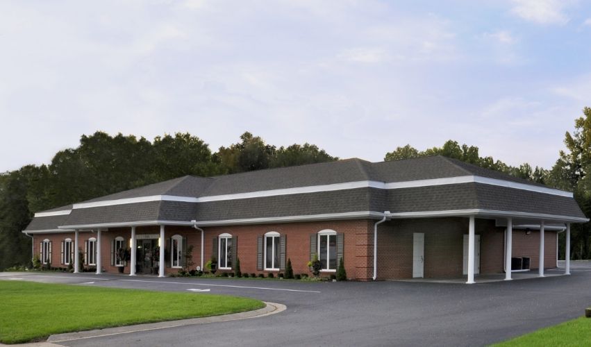 A large brick building with a black roof