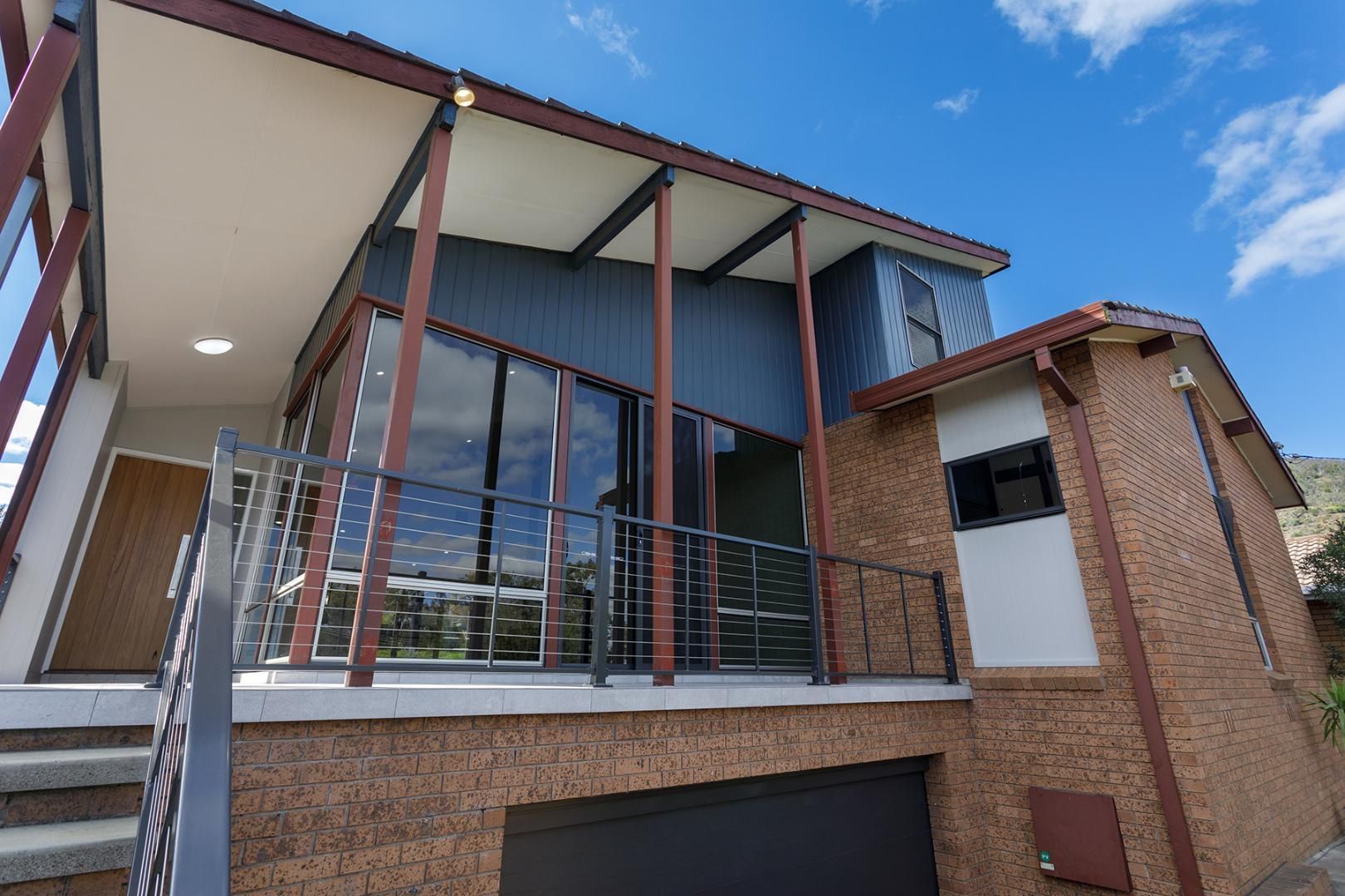 A Large House With a Balcony and Stairs — Kareela Constructions In Tamworth, NSW
