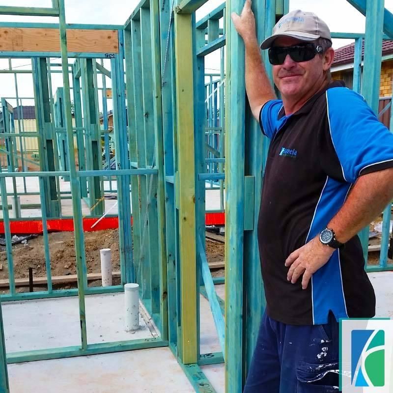 A Man and a Woman Are Standing in a Kitchen— Kareela Constructions In Tamworth, NSW