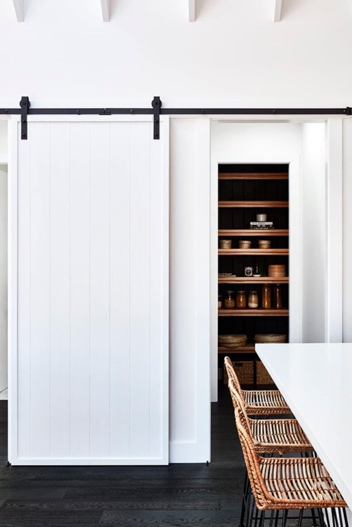 A Dining Room With a Sliding Barn Door Leading to a Pantry - Kareela Constructions In Tamworth, NSW