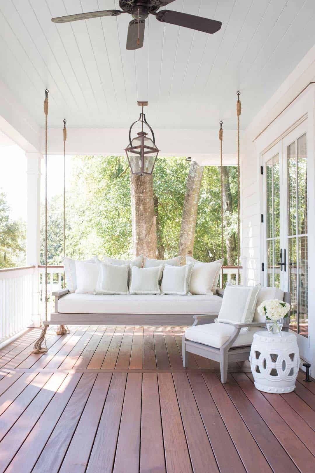 A Porch With a Swing, Chair, Table and Ceiling Fan — Kareela Constructions In Tamworth, NSW