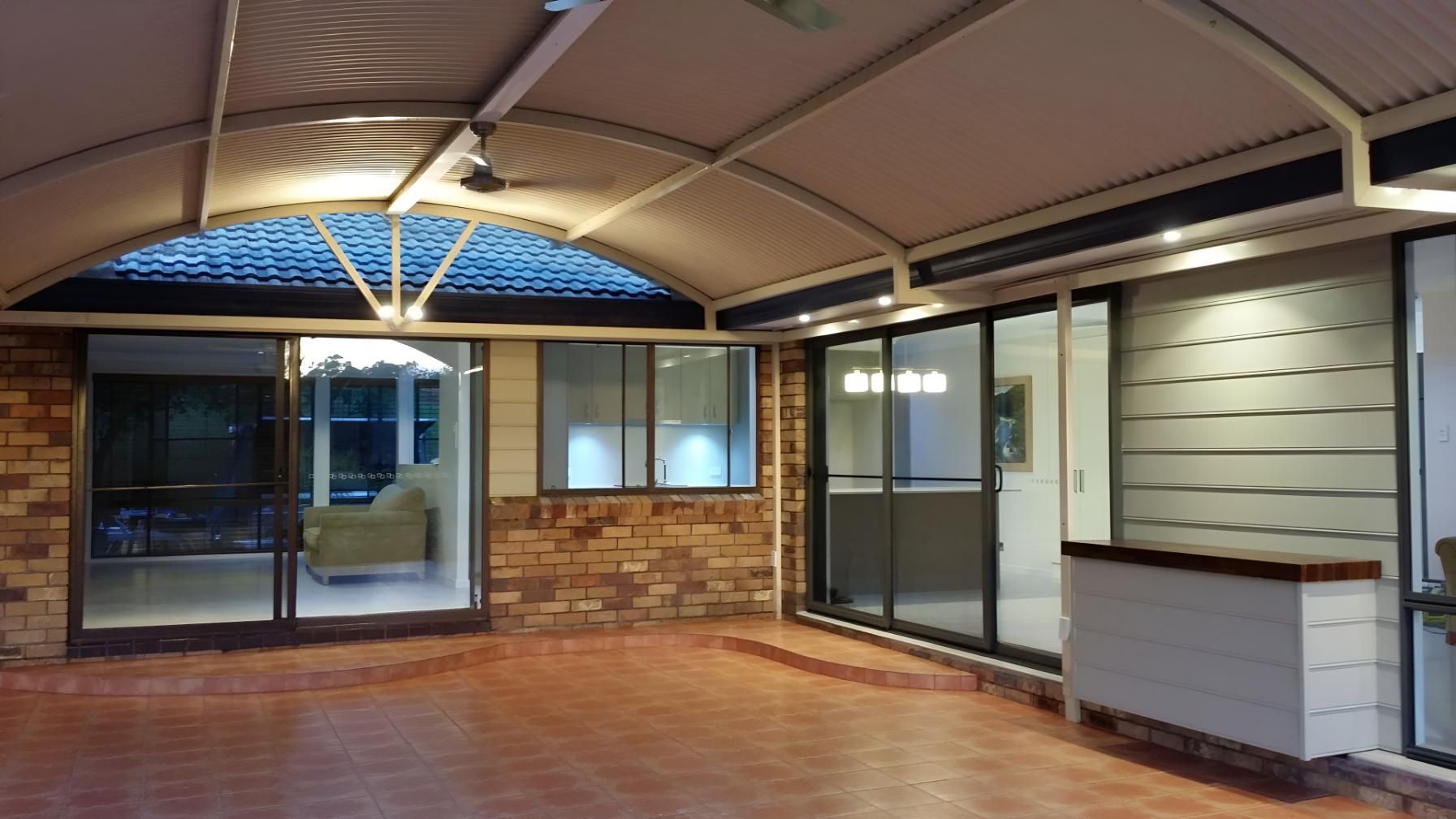 An Empty Room With a Brick Wall and Sliding Glass Doors — Kareela Constructions In Tamworth, NSW