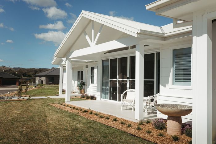 White house with porch and lawn; clear sky. — Kareela Constructions In Tamworth, NSW