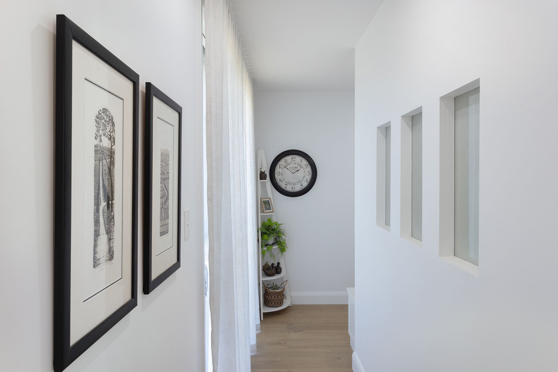 A Hallway With Art On The Wall — Kareela Constructions In Tamworth, NSW